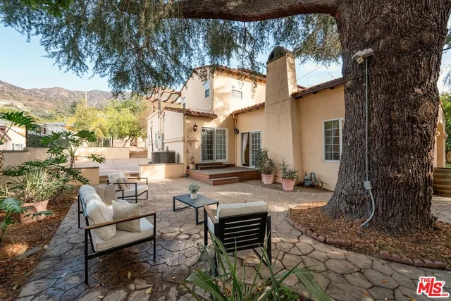 a living room with fireplace furniture and a wooden floor