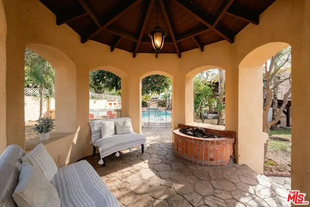 a spacious bedroom with a bed and a view of kitchen