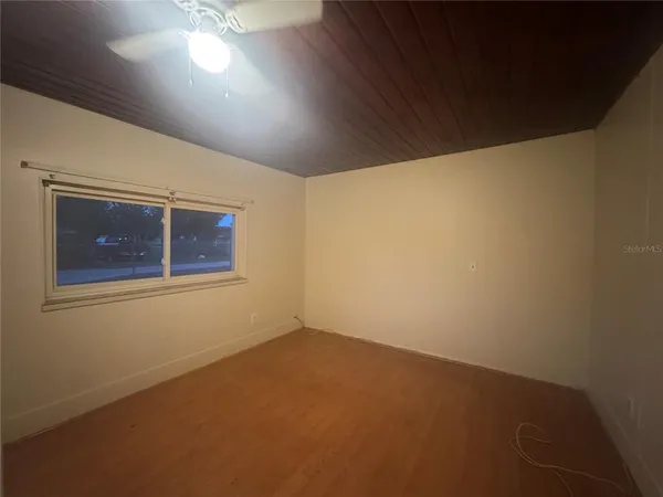 an empty room with a empty space and windows