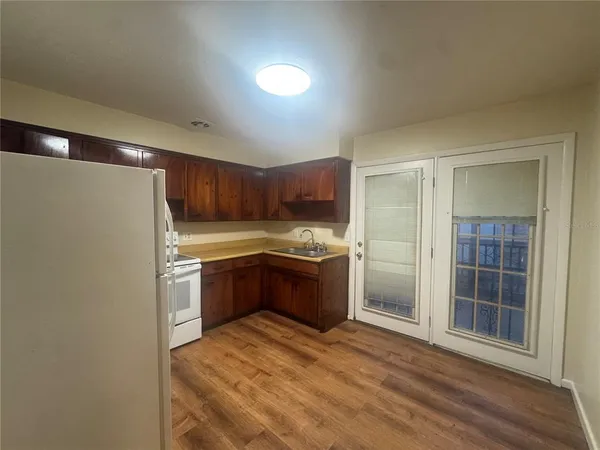 a kitchen with stainless steel appliances granite countertop a refrigerator and a sink