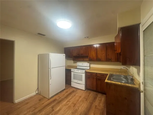 a kitchen with a refrigerator sink and stove