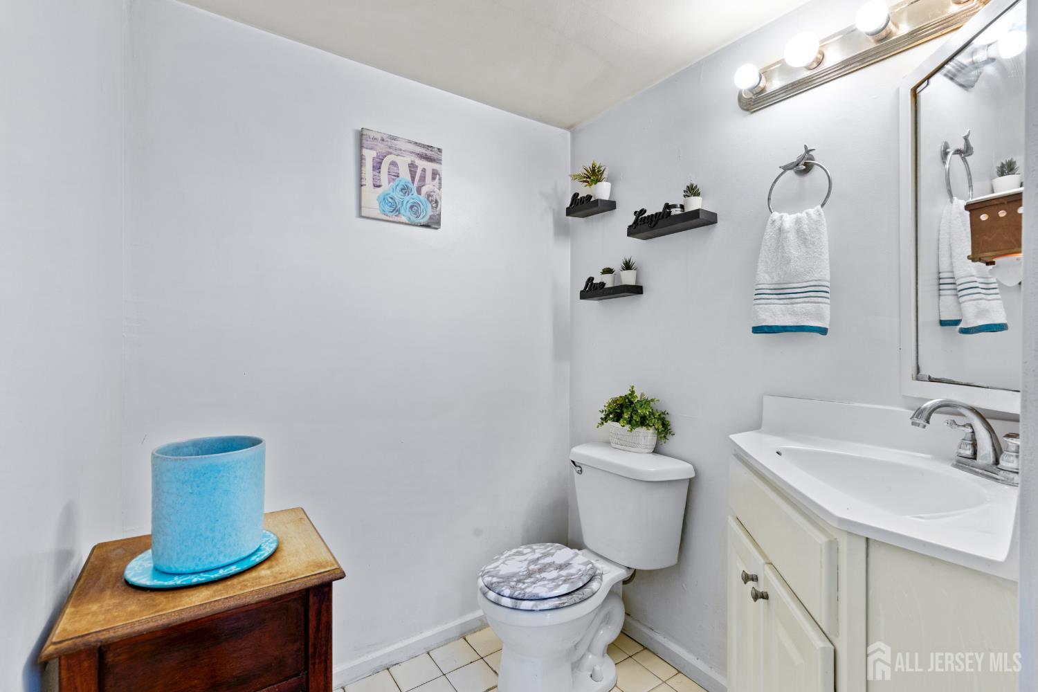40 Fayette Street, Unit 26 Perth Amboy, NJ 08861 - Photo 11 of 20 a bathroom with a sink mirror and toilet
