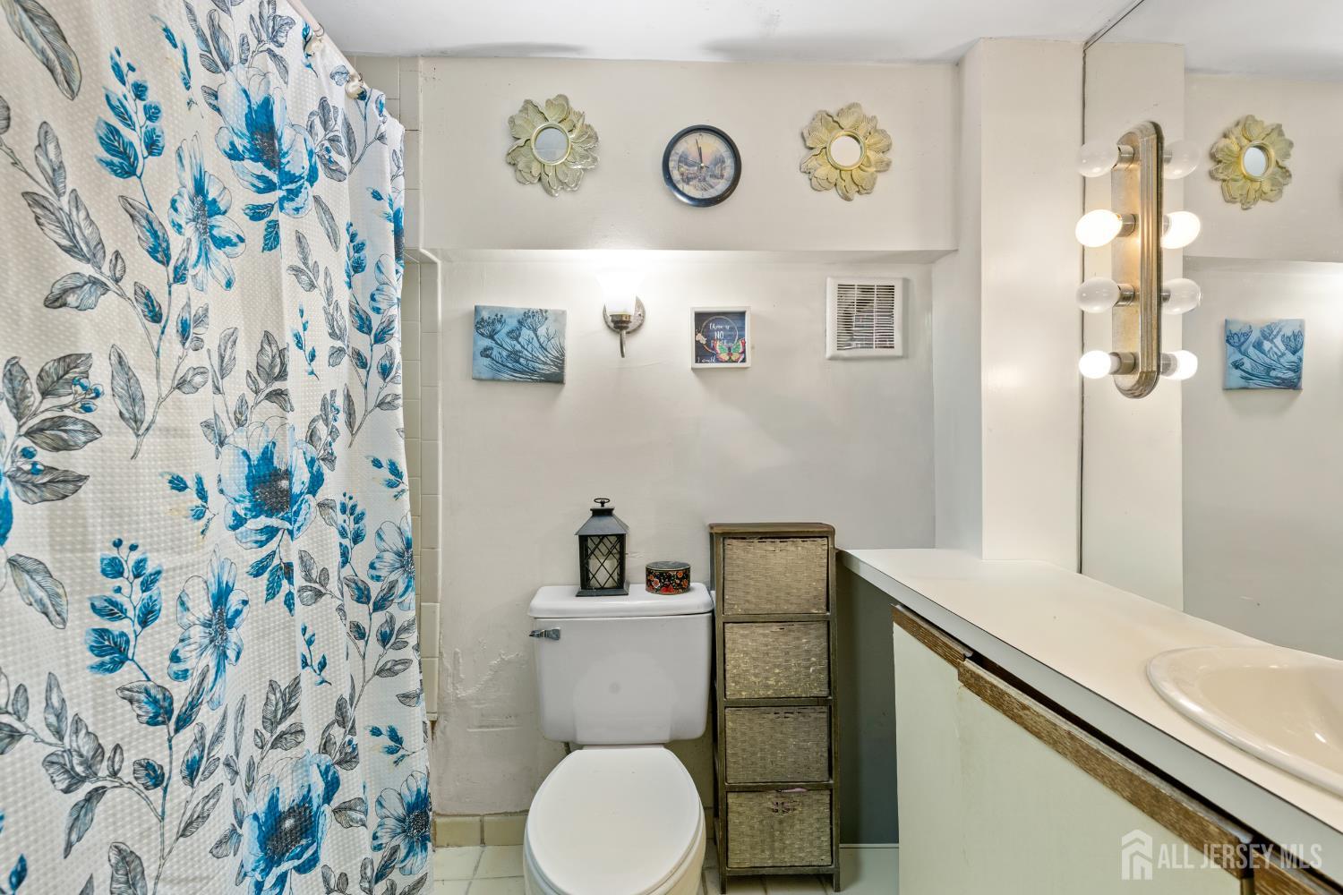 40 Fayette Street, Unit 26 Perth Amboy, NJ 08861 - Photo 15 of 20 a bathroom with a granite countertop sink and a toilet