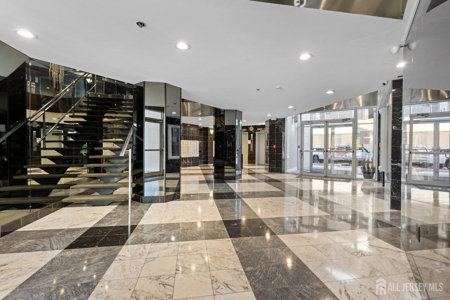 40 Fayette Street, Unit 26 Perth Amboy, NJ 08861 - Photo 2 of 20 a lobby with a rug and glass door