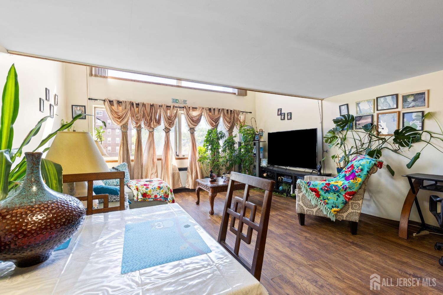 40 Fayette Street, Unit 26 Perth Amboy, NJ 08861 - Photo 4 of 20 a living room with furniture and a flat screen tv