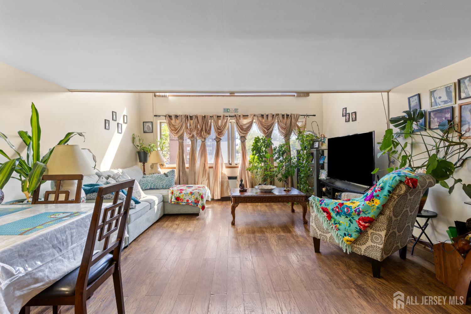 40 Fayette Street, Unit 26 Perth Amboy, NJ 08861 - Photo 6 of 20 a living room with furniture and a flat screen tv