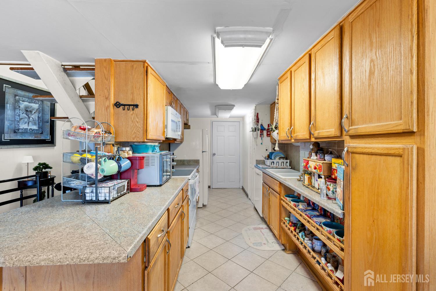 40 Fayette Street, Unit 26 Perth Amboy, NJ 08861 - Photo 10 of 20 a kitchen with stainless steel appliances granite countertop a sink and a large window
