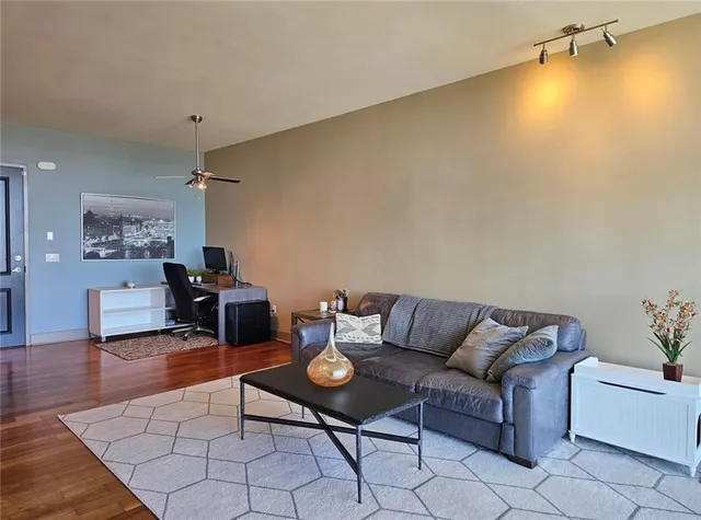 a living room with furniture and wooden floor