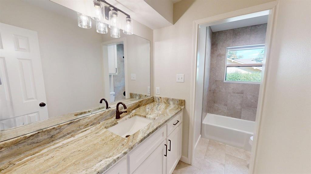 1110 Mill Run Road Athens, TX 75751 - Photo 19 of 32 a spacious bathroom with a granite countertop sink a mirror and shower