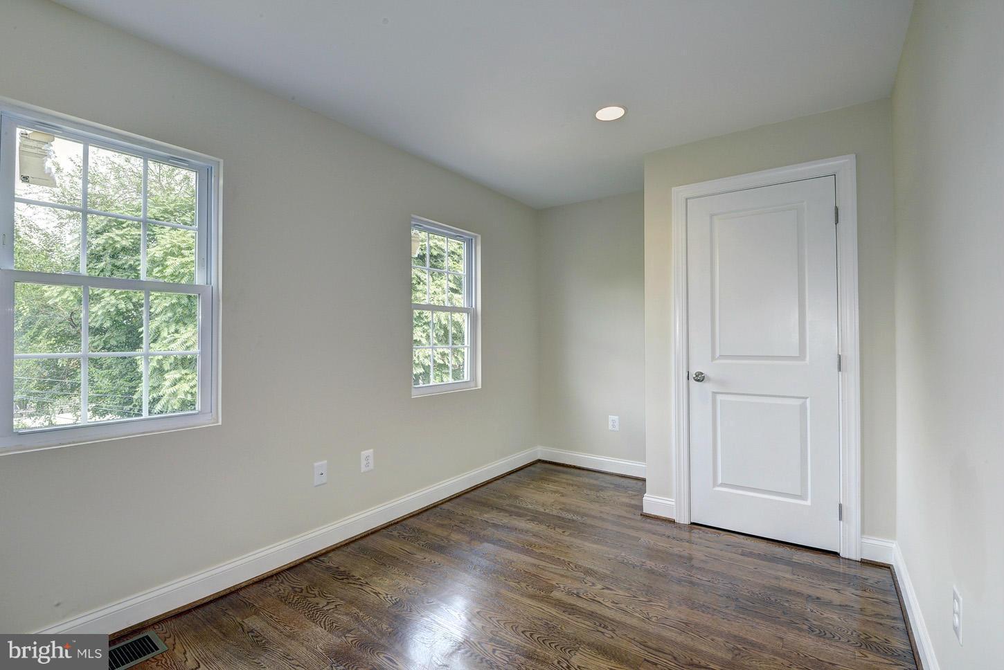 2428 4th Street Northeast Washington, DC 20002 - Photo 17 of 28 a view of an empty room with wooden floor and a window