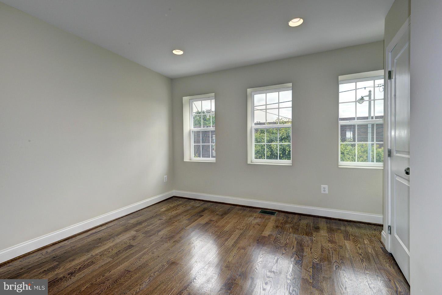 2428 4th Street Northeast Washington, DC 20002 - Photo 7 of 28 an empty room with wooden floor and windows
