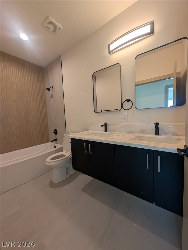4670 Medicine Man Road Pahrump, NV 89048 - Photo 24 of 36 A well-lit bathroom with a spacious double vanity and a bathtub features sleek, modern fixtures.