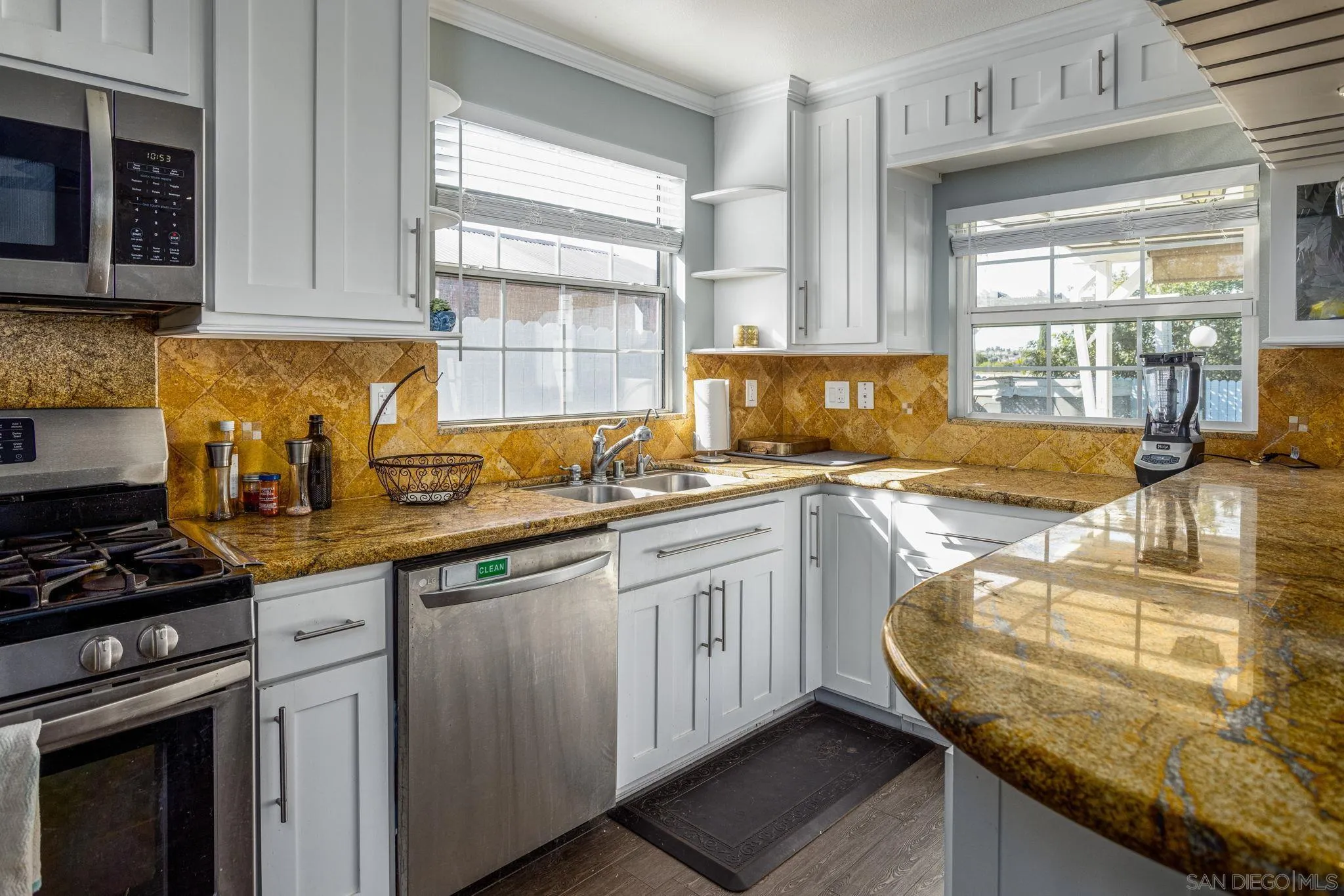 532 Kempton Street Spring Valley, CA 91977 - Photo 7 of 30 a kitchen with granite countertop a sink a stove and cabinets