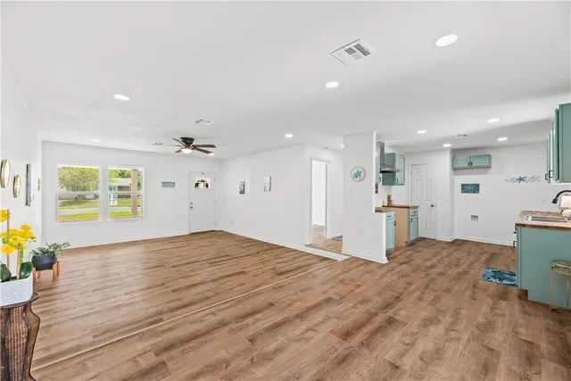 a living room with a table and a mirror