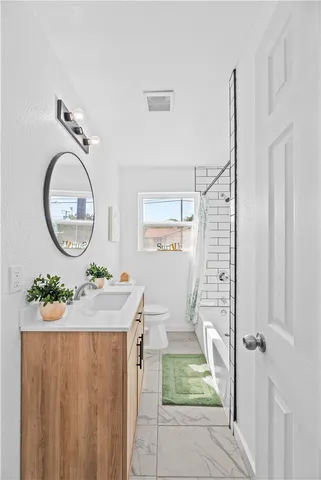 a kitchen with a sink a stove and a refrigerator