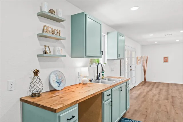 a large kitchen with stainless steel appliances granite countertop a sink stove and refrigerator