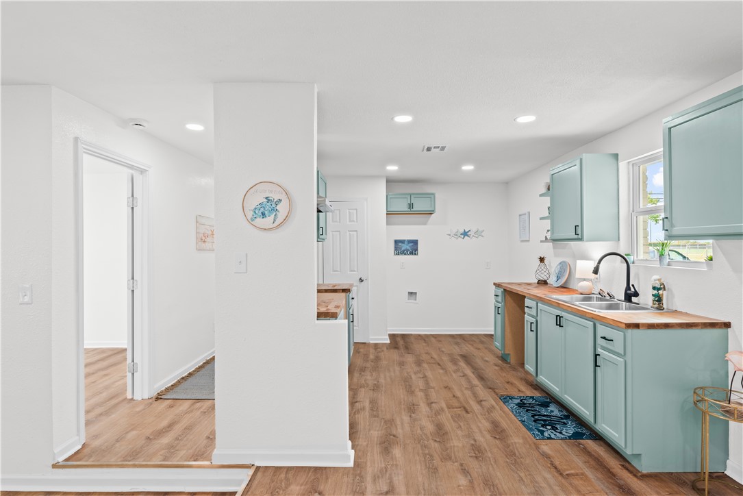 2575 San Angelo Avenue Ingleside, TX 78362 - Photo 15 of 38 a large white kitchen with a sink a refrigerator and a stove
