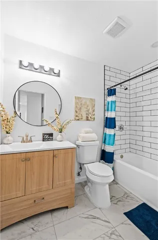 a bathroom with a sink a mirror a toilet and a bathtub