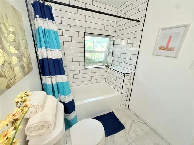 a bathroom with a bathtub and window