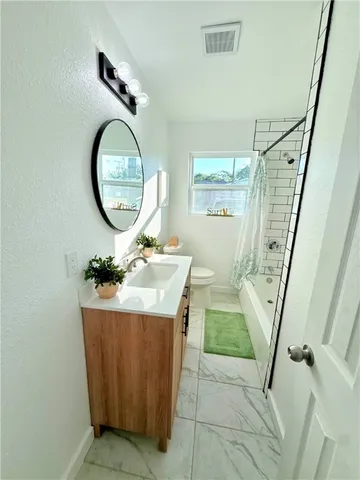 a bathroom with a sink a bathtub and a mirror