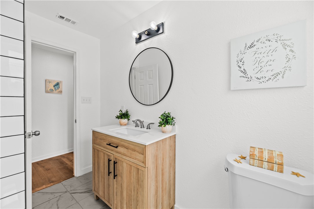 2575 San Angelo Avenue Ingleside, TX 78362 - Photo 33 of 38 a bathroom with a sink a vanity and a mirror
