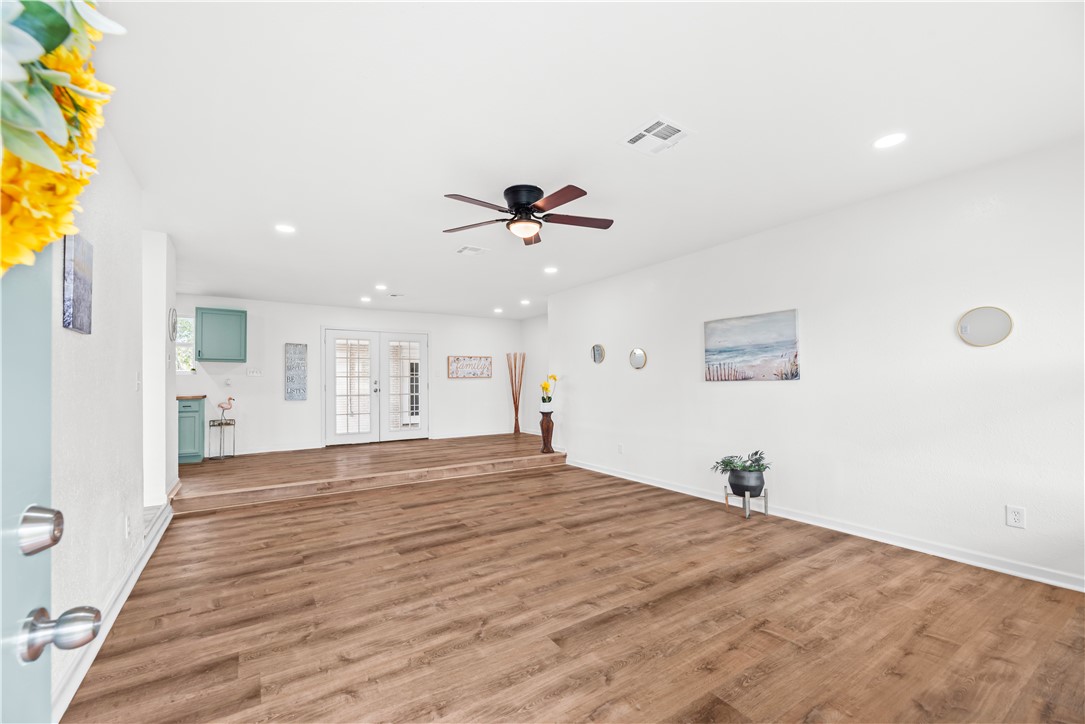 2575 San Angelo Avenue Ingleside, TX 78362 - Photo 7 of 38 a view of a livingroom with a hardwood floor and a ceiling fan