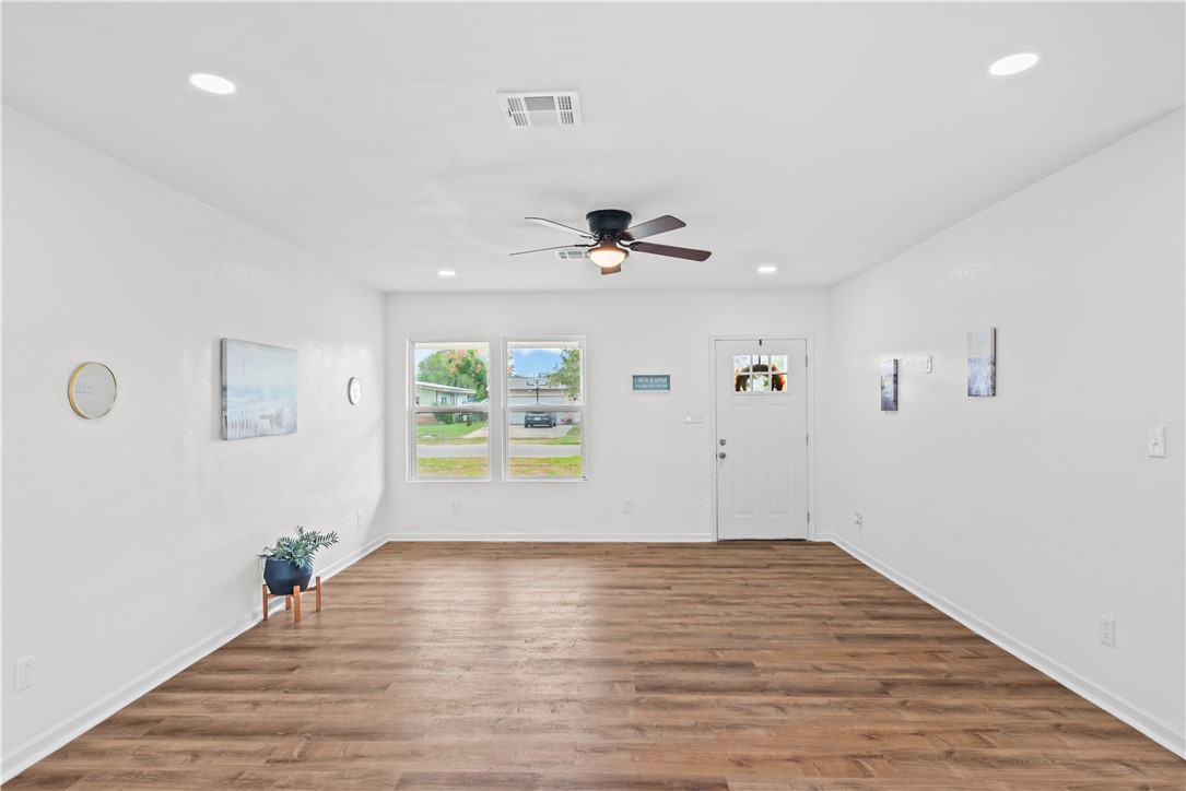 2575 San Angelo Avenue Ingleside, TX 78362 - Photo 9 of 38 wooden floor in an empty room with a window