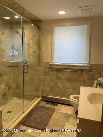 a bathroom with a shower and a sink