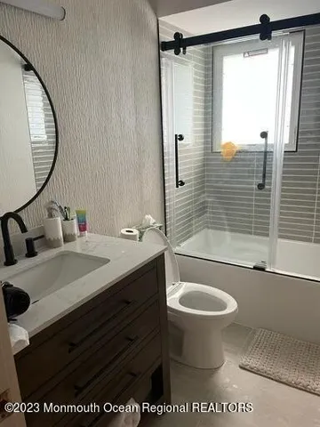 a bathroom with a sink toilet and shower