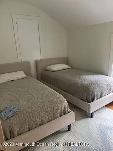 a bedroom with a bed rug and wall painting