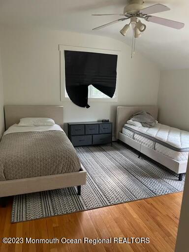 7 Slocum Place Oakhurst, NJ 07755 - Photo 10 of 14 a bedroom with a bed a mirror and lamp on dresser