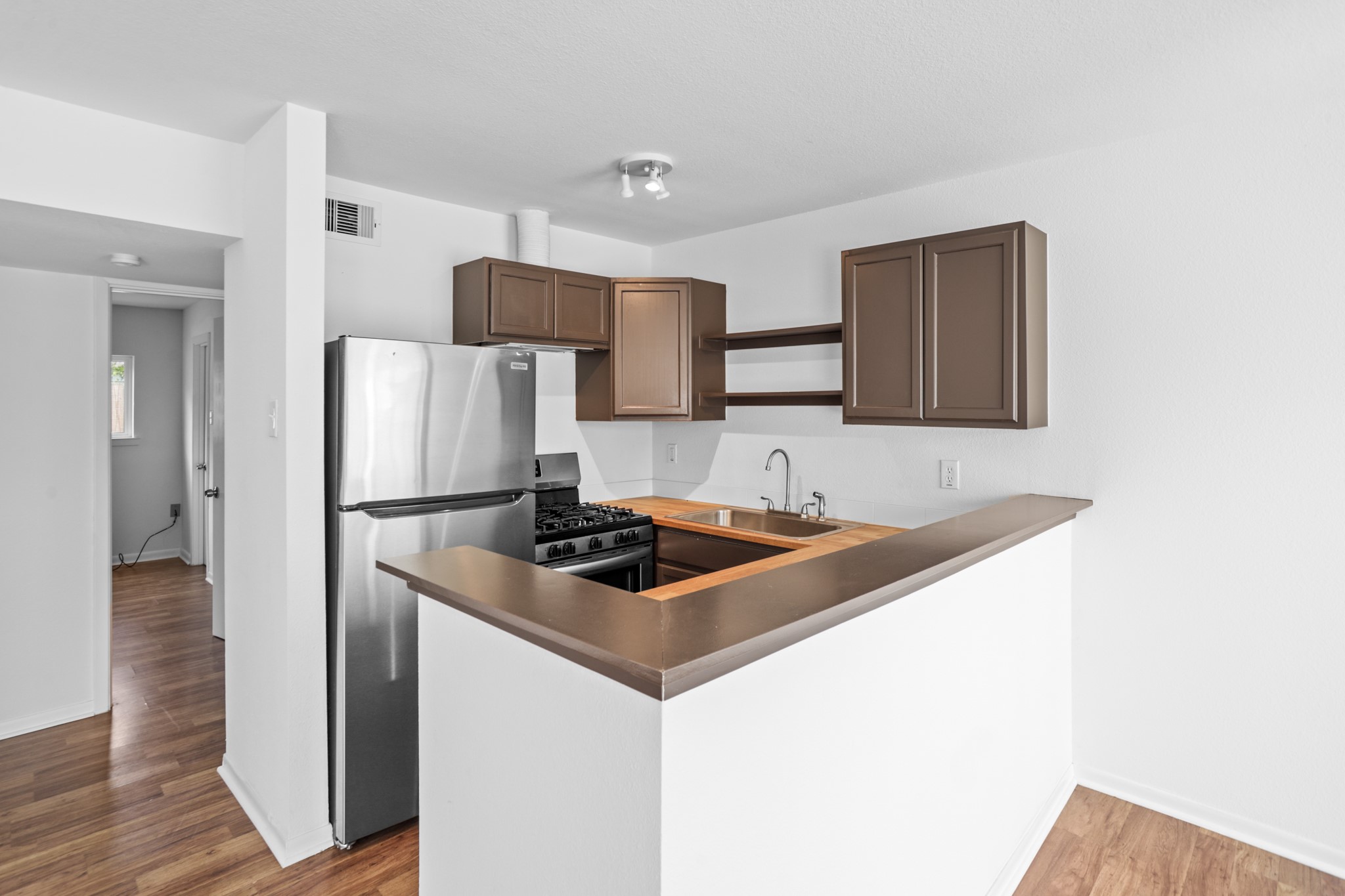 1408 Hughes Street, Unit 4 Houston, TX 77023 - Photo 17 of 27 Recently updated kitchen with stainless steel appliances. The units include a refrigerator, stove and dishwasher.