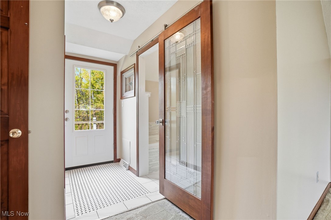 11710 Butternut Road Chardon, OH 44024 - Photo 26 of 48 Entryway with tile patterned flooring and baseboards to owners suite bath