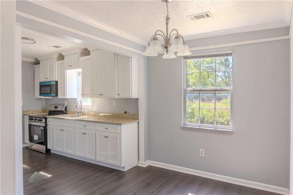 53 Washington Drive Forsyth, GA 31029 - Photo 5 of 19 a kitchen with stainless steel appliances granite countertop a stove a sink dishwasher a refrigerator and a window