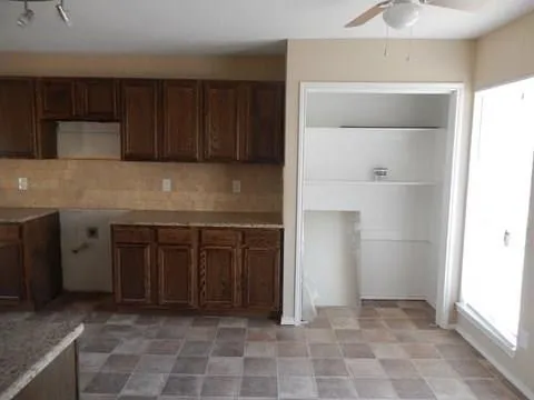 a kitchen with a cabinets and a stove top oven