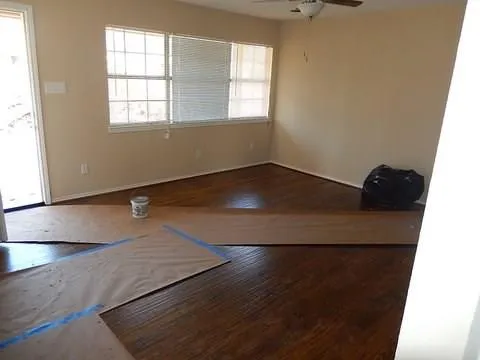 an empty room with wooden floor