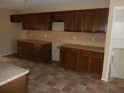 a kitchen with a cabinets and a stove top oven