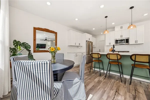 a living room with furniture and kitchen view