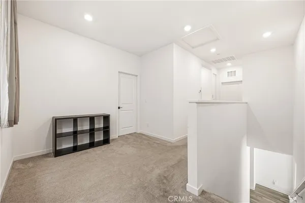 an empty room with closet and windows