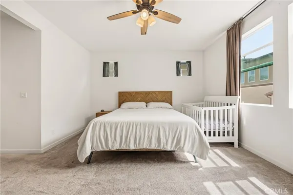 a bedroom with a bed and window