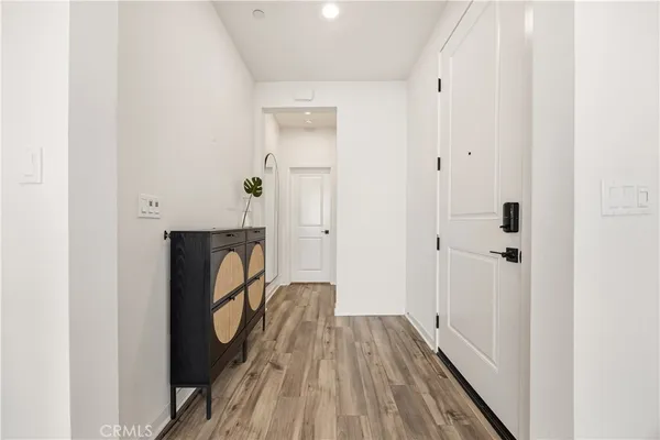 a view of a hallway with wooden floor and staircase