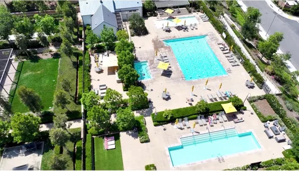 an aerial view of residential house with yard and swimming pool