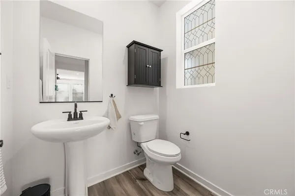 a bathroom with a sink toilet and mirror