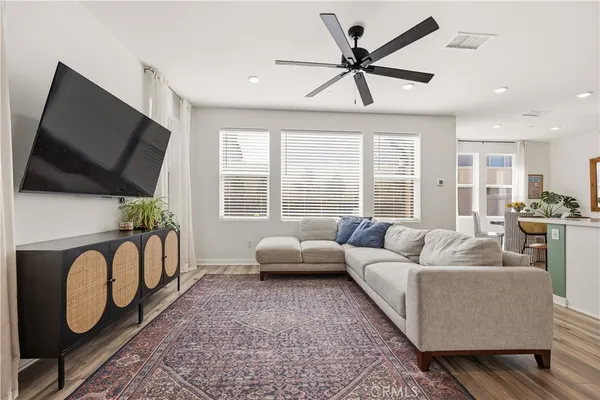 a living room with furniture tv and a large window