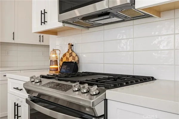a stove top oven sitting inside of a kitchen
