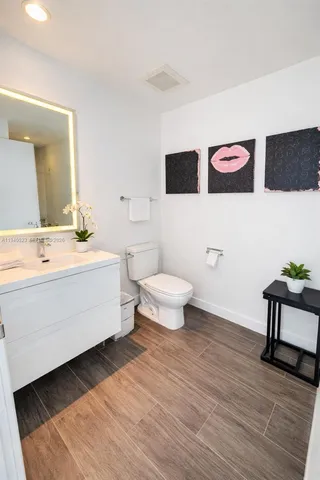 a bathroom with a double vanity sink mirror and toilet