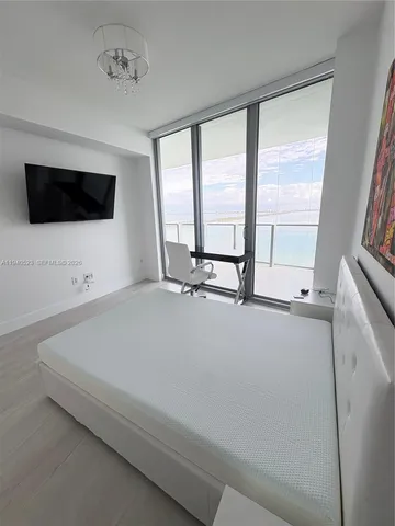 a living room with a large window and a flat screen tv