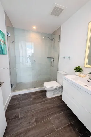 a bathroom with a toilet and a shower