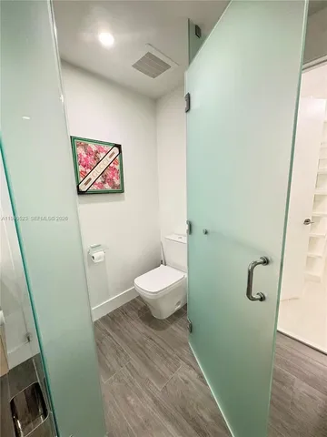 a bathroom with a toilet and a shower