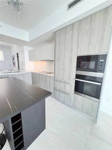 a kitchen with wooden cabinets and a stove top oven